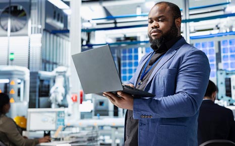 African American man looks at data on a laptop computer